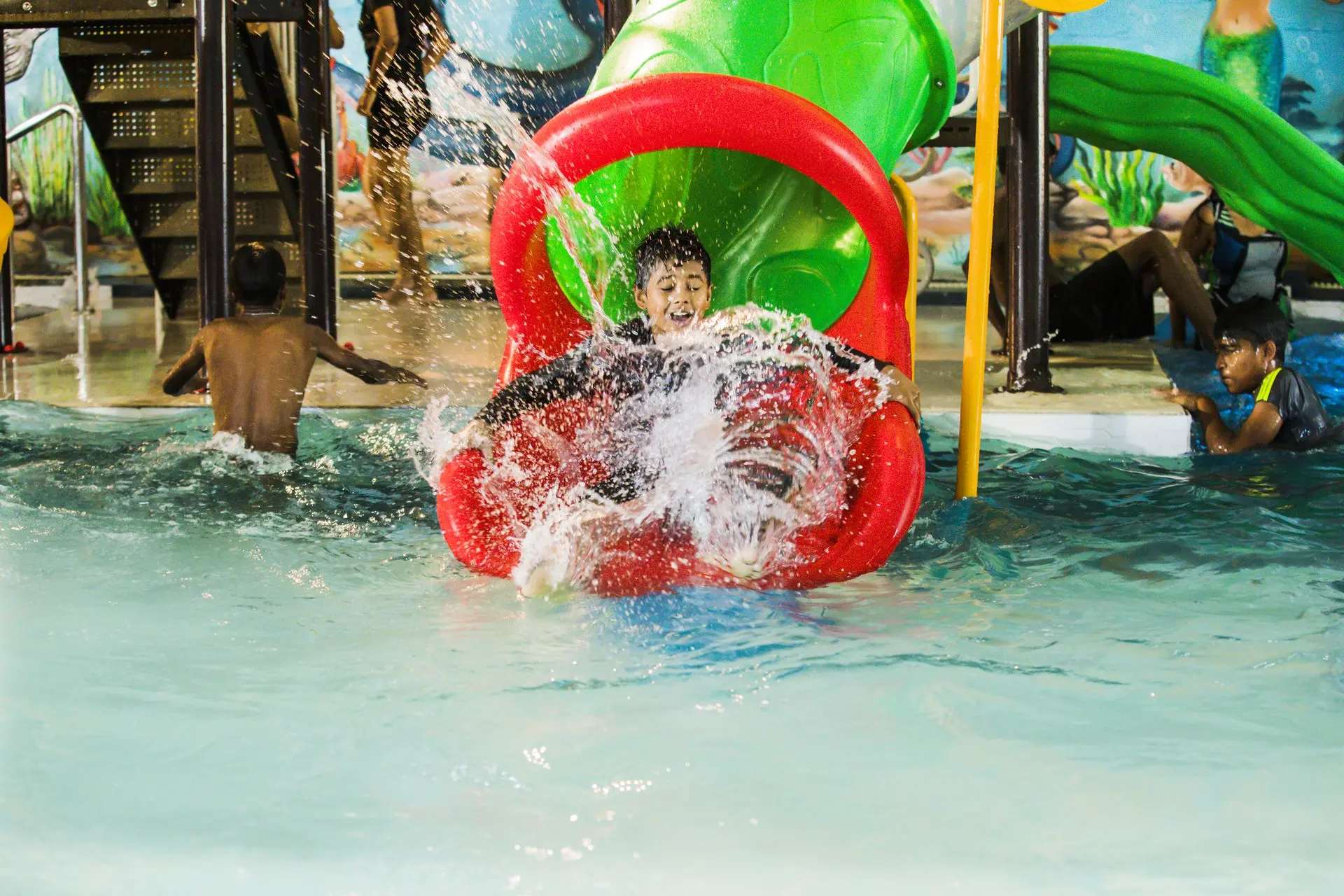 Kids sliding down a slide